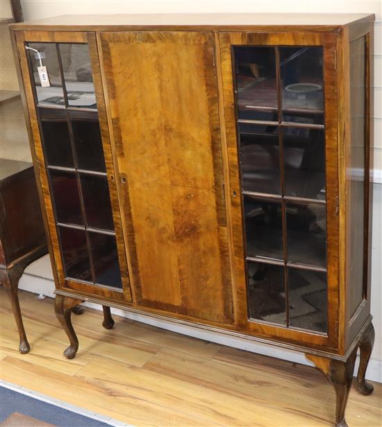 An early 20th century glazed walnut cabinet W.122cm